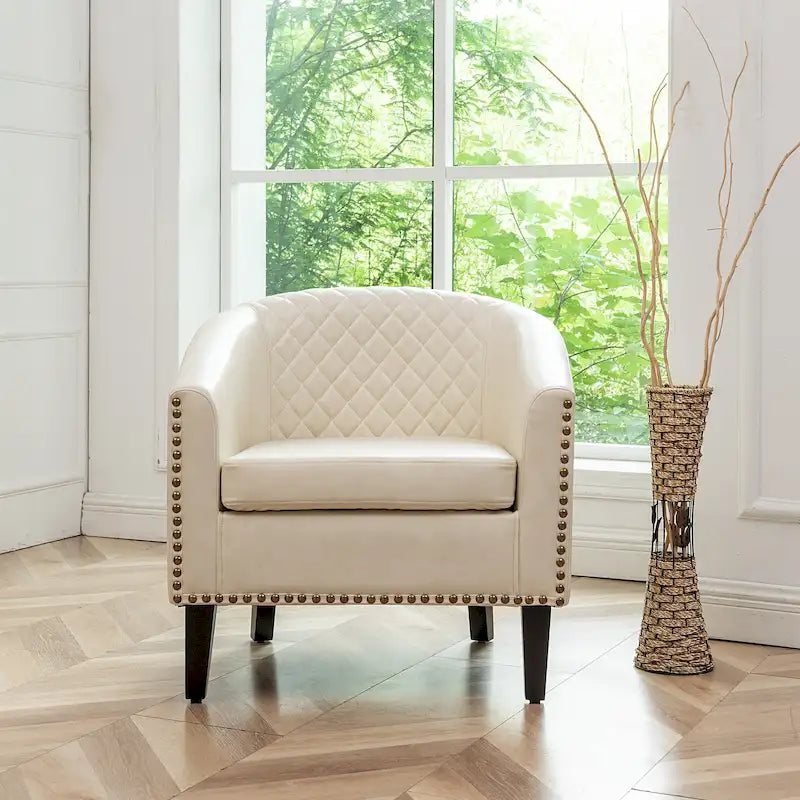 Fauteuil club en similicuir capitonné, avec clous décoratifs