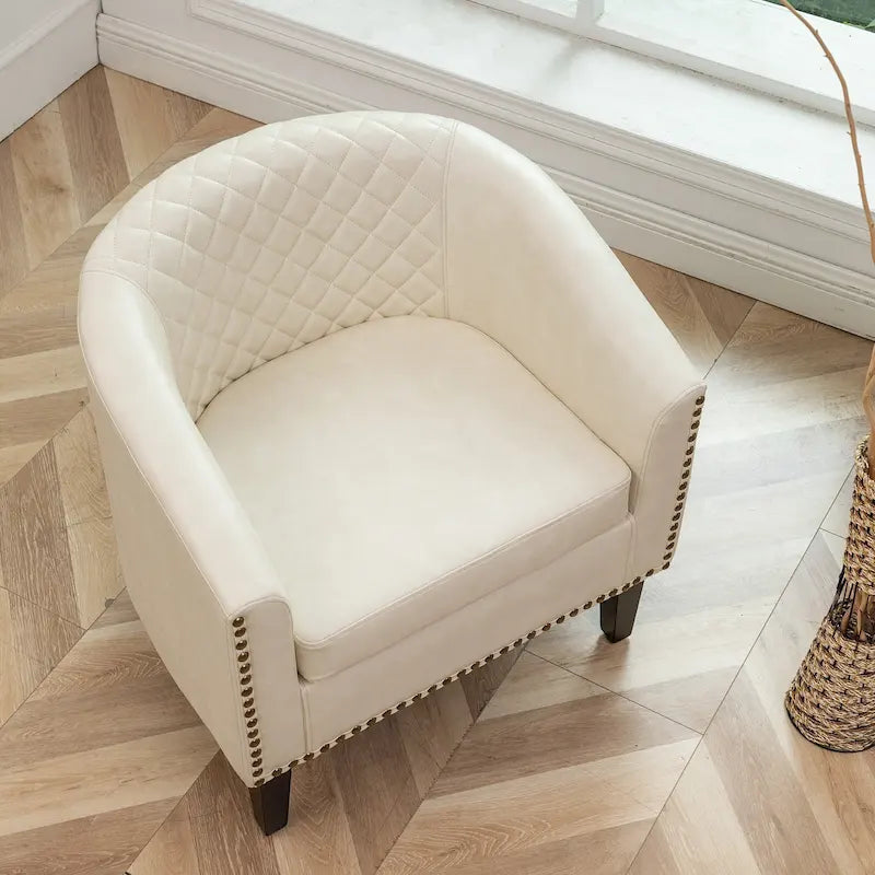 Fauteuil club en similicuir capitonné, avec clous décoratifs