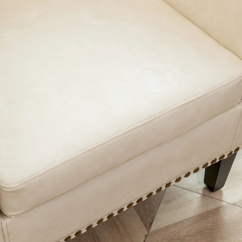 Fauteuil club en similicuir capitonné, avec clous décoratifs