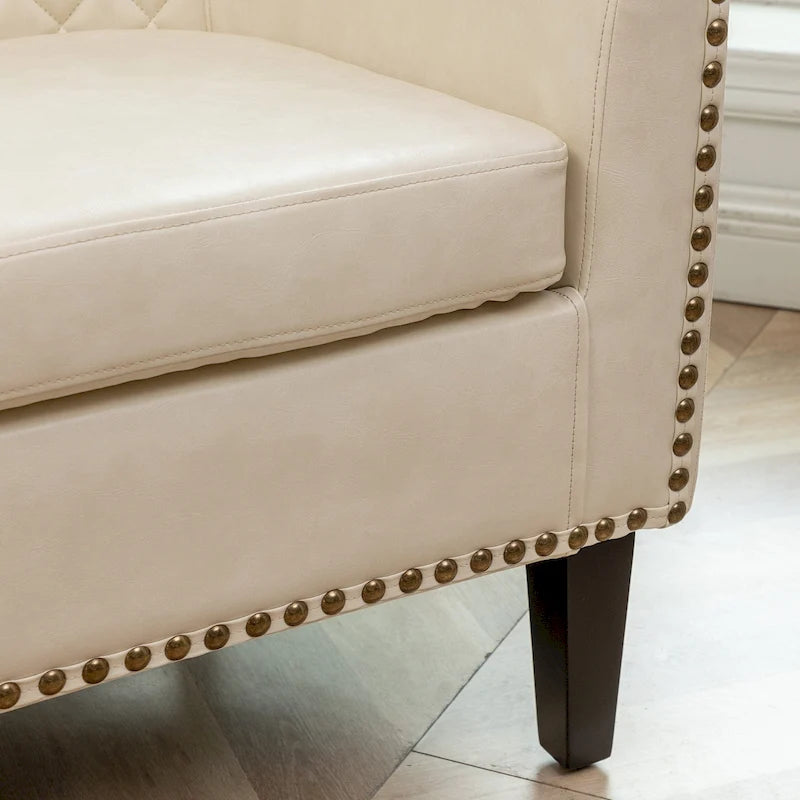 Fauteuil club en similicuir capitonné, avec clous décoratifs