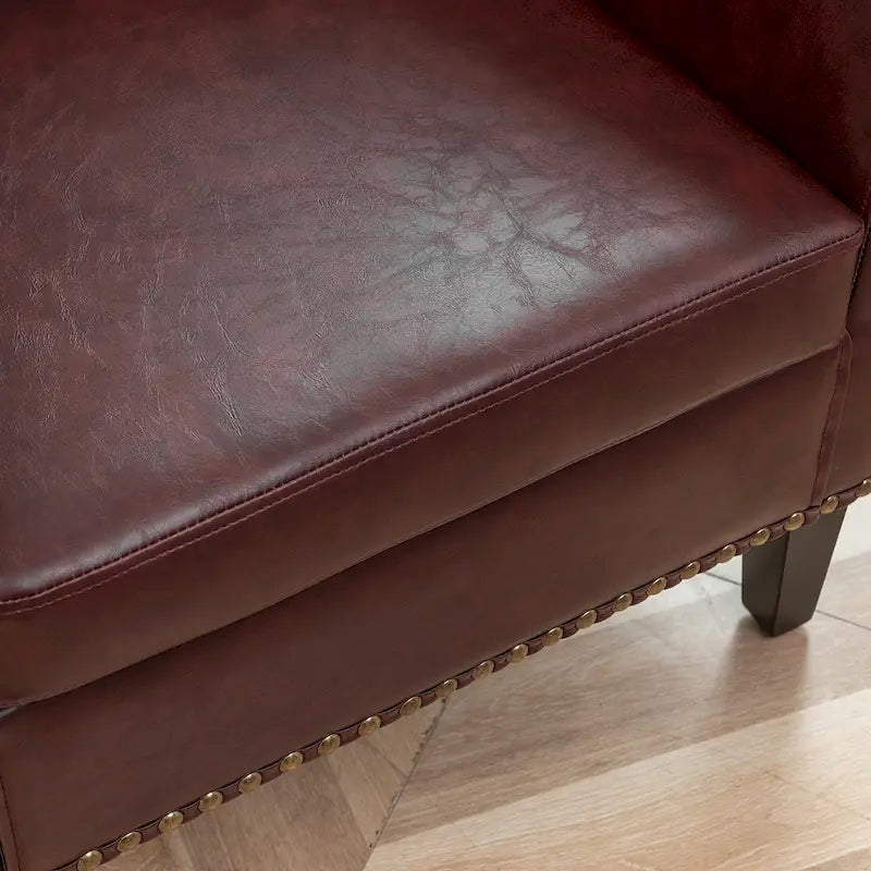 Fauteuil club en similicuir capitonné, avec clous décoratifs