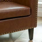 Fauteuil club en similicuir capitonné, avec clous décoratifs