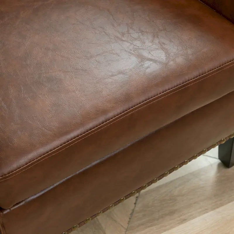 Fauteuil club en similicuir capitonné, avec clous décoratifs