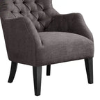 Fauteuil à dossier haut à chevrons et capitonnage.
